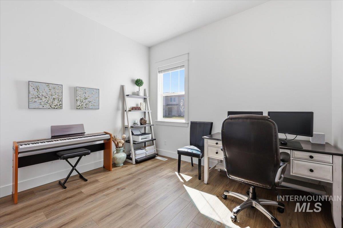 5512 North Ebony Way Meridian, ID 83646 - Photo 31 of 40 Bedroom staged as an office featuring light wood-type flooring and baseboards