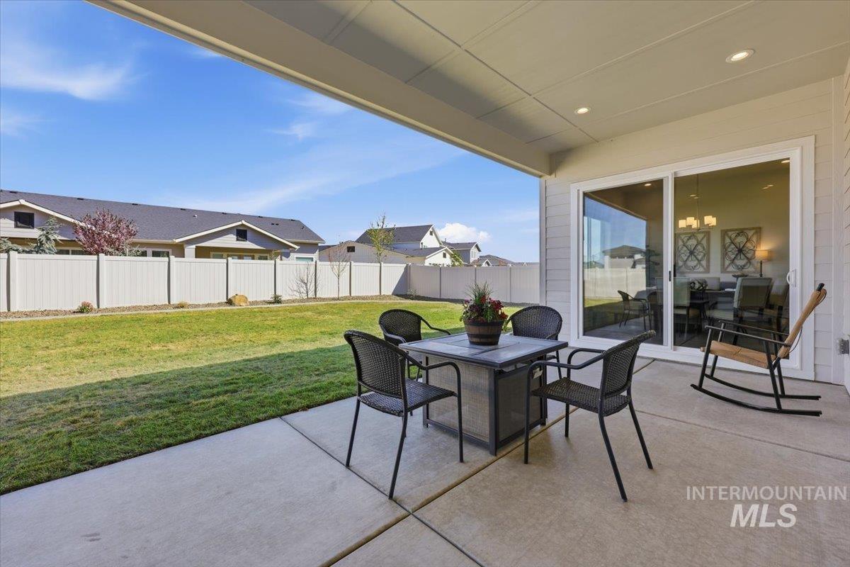 5512 North Ebony Way Meridian, ID 83646 - Photo 32 of 40 Fenced backyard featuring a patio and outdoor dining area