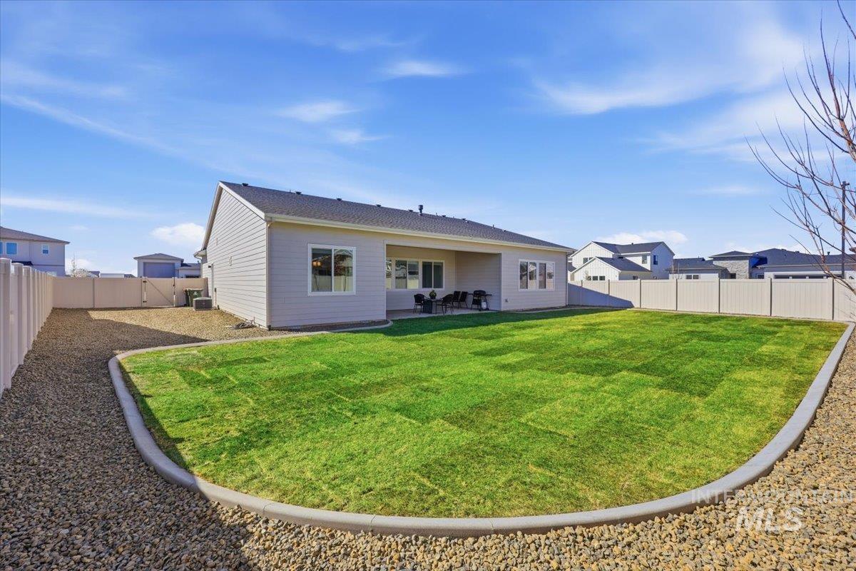 5512 North Ebony Way Meridian, ID 83646 - Photo 34 of 40 Rear view of house with a fenced backyard, a patio area, and a residential view