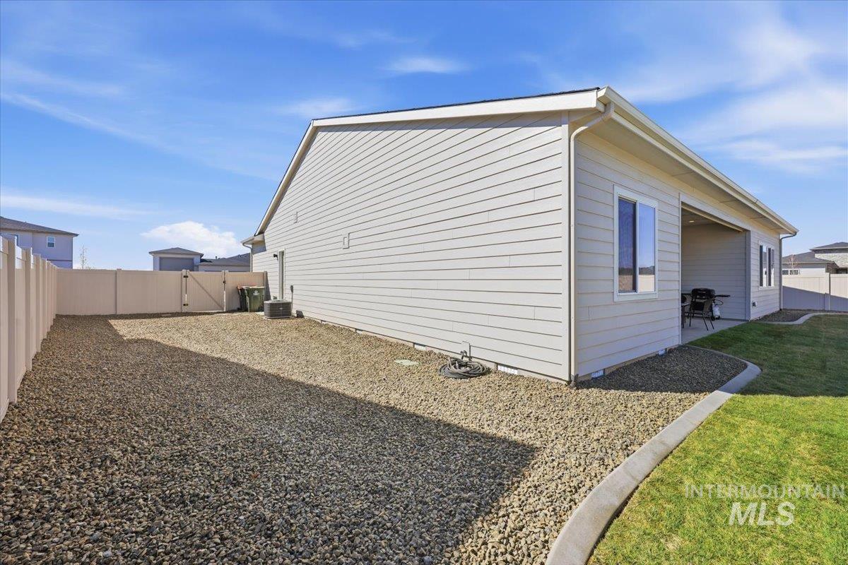 5512 North Ebony Way Meridian, ID 83646 - Photo 35 of 40 View of side of home featuring a fenced backyard, a gate, and a patio area. Large enough for potential RV Access.