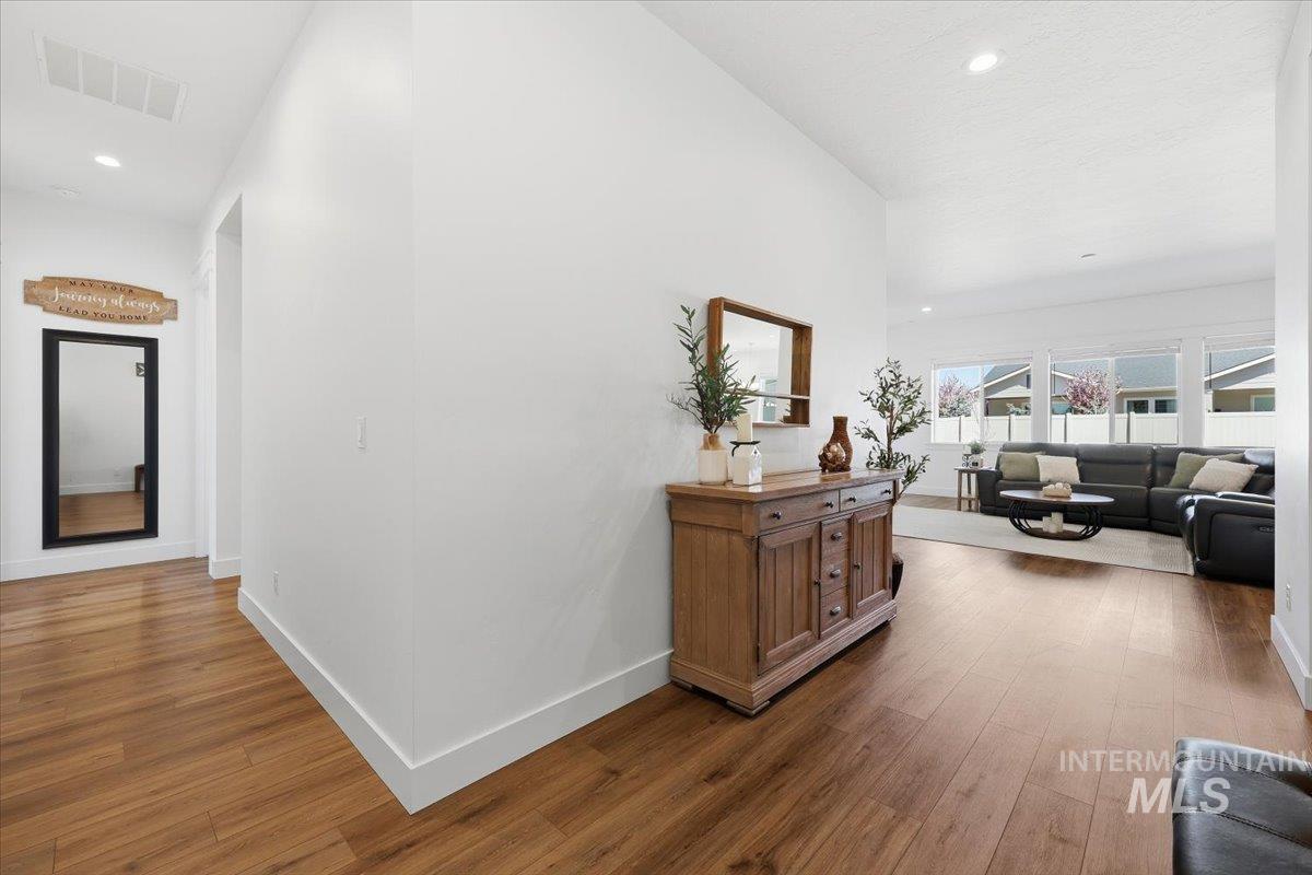 5512 North Ebony Way Meridian, ID 83646 - Photo 6 of 40 Corridor with dark wood-style flooring, recessed lighting, and lofted ceiling