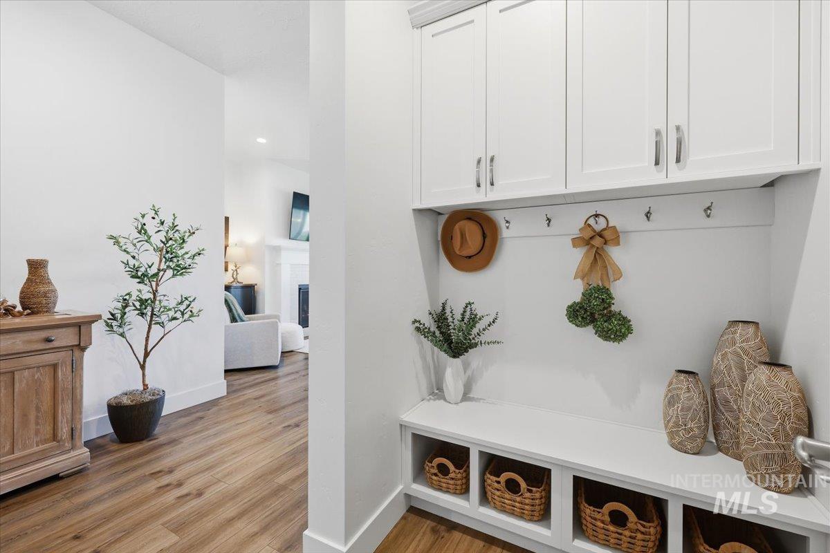 5512 North Ebony Way Meridian, ID 83646 - Photo 7 of 40 Mudroom featuring a fireplace and light wood-style floors