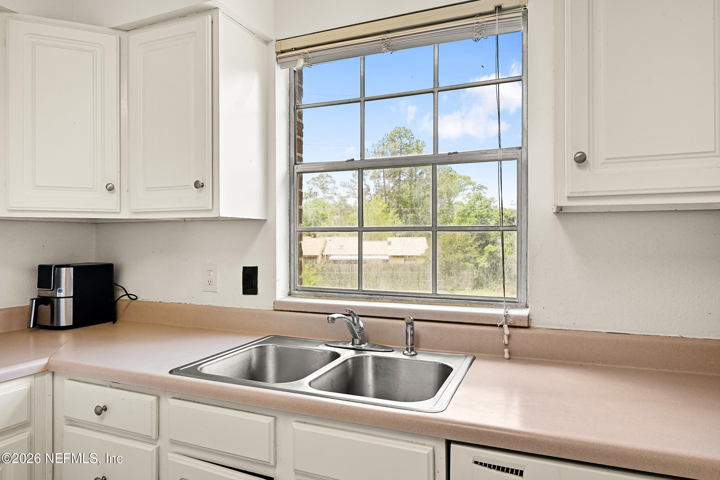 4915 Baymeadows Road, Unit 6G Jacksonville, FL 32217 - Photo 13 of 44 a kitchen with a sink and cabinets