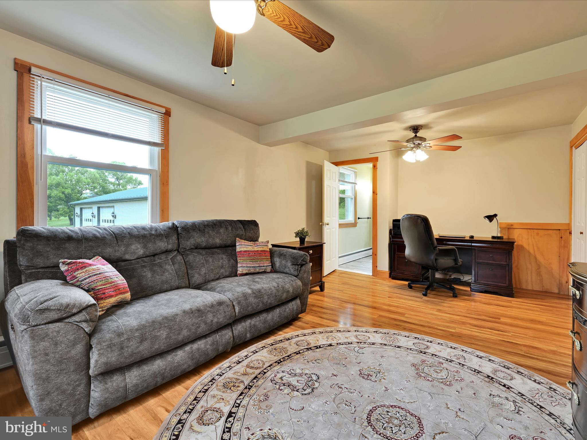 1553 St Peters Road Pottstown, PA 19465 - Photo 11 of 33 a living room with furniture a chandelier and a dining table