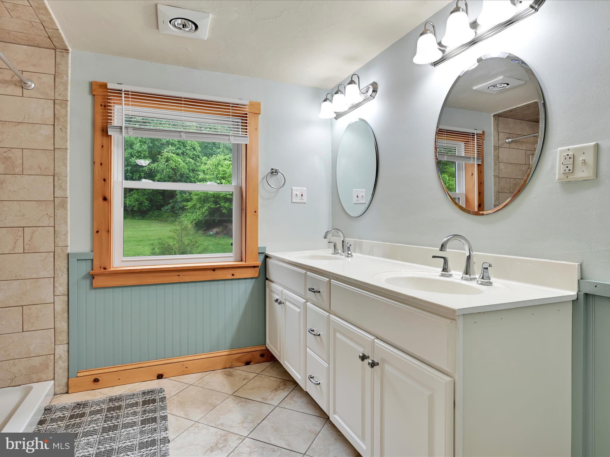 1553 St Peters Road Pottstown, PA 19465 - Photo 17 of 33 a bathroom with a double vanity sink and a mirror