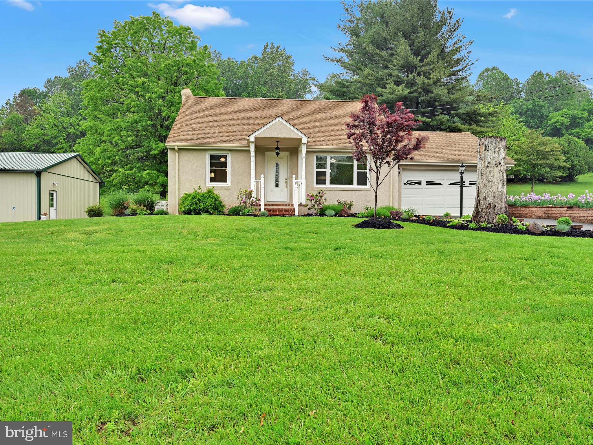 1553 St Peters Road Pottstown, PA 19465 - Photo 2 of 33 a front view of a house with a garden