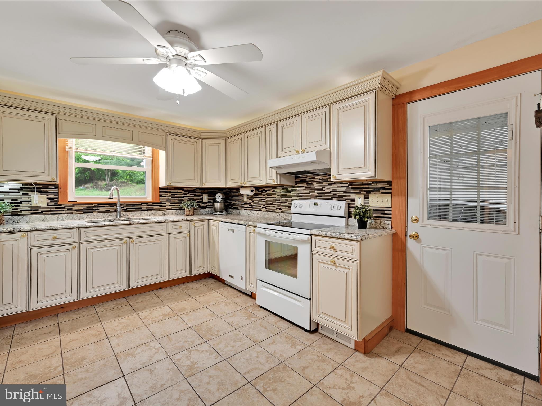 1553 St Peters Road Pottstown, PA 19465 - Photo 8 of 33 a kitchen with stainless steel appliances granite countertop a stove a sink and a refrigerator