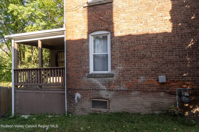 a view of a brick house with a large windows
