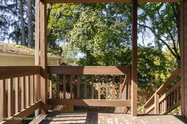 a view of a balcony with wooden fence and floor