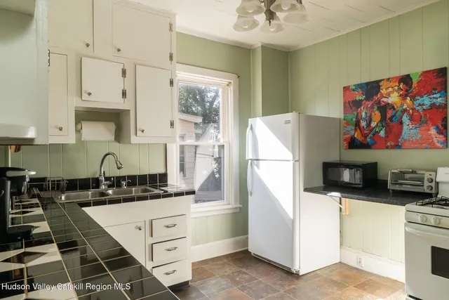 a kitchen with stainless steel appliances a refrigerator sink and cabinets