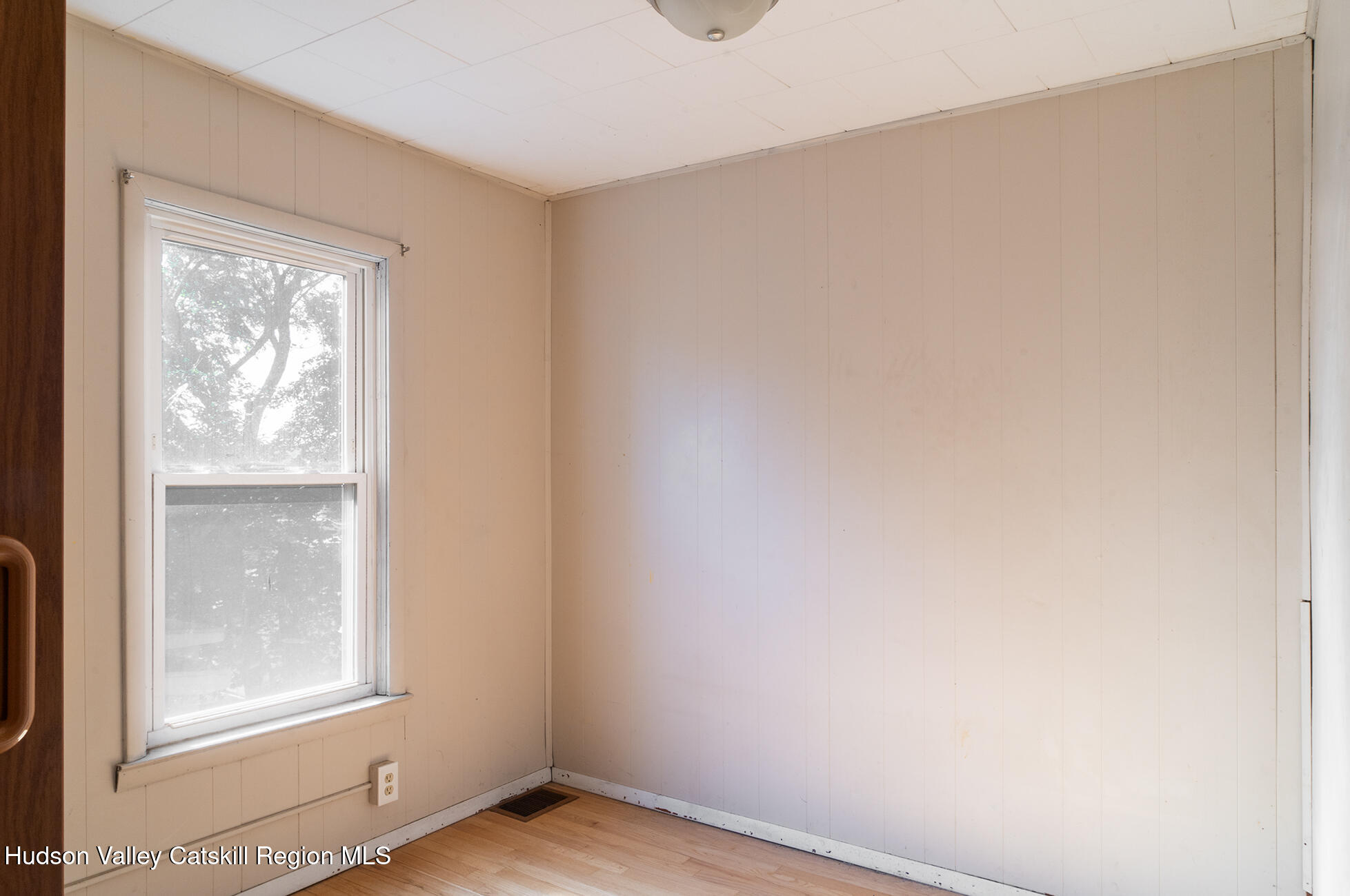 71 New Street Catskill, NY 12414 - Photo 10 of 13 a view of an empty room with wooden floor and a window