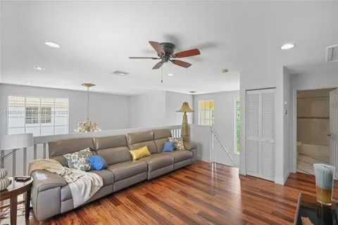 a room with gym equipment and wooden floor