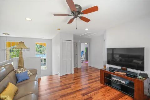 a view of room with walk in closet and wooden floor