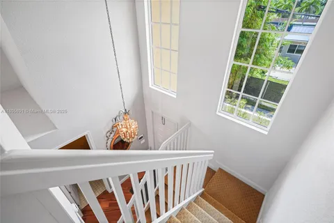 a large kitchen with stainless steel appliances and large windows