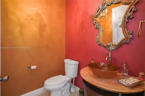 a kitchen with stainless steel appliances granite countertop a refrigerator a stove and a wooden cabinets