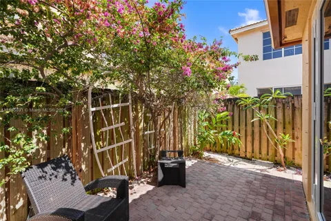 a kitchen with stainless steel appliances kitchen island granite countertop a refrigerator and a stove top oven with wooden floor