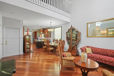 an aerial view of a house with swimming pool and porch