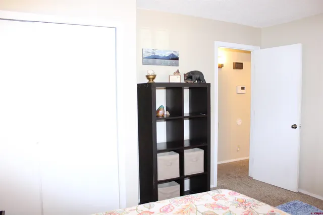 a bedroom with a bed and a lamp on table