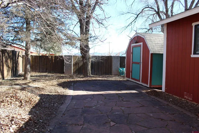 a view of backyard with large trees