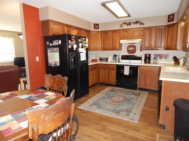 a bed room with a bed and a kitchen