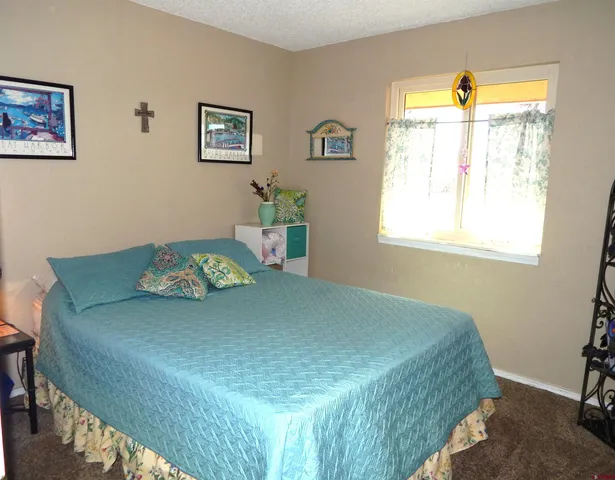 a view of a dining room with furniture and a window