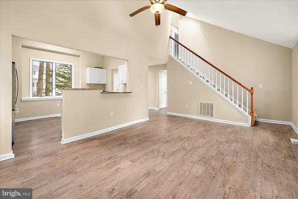 a dining room with furniture a chandelier and wooden floor