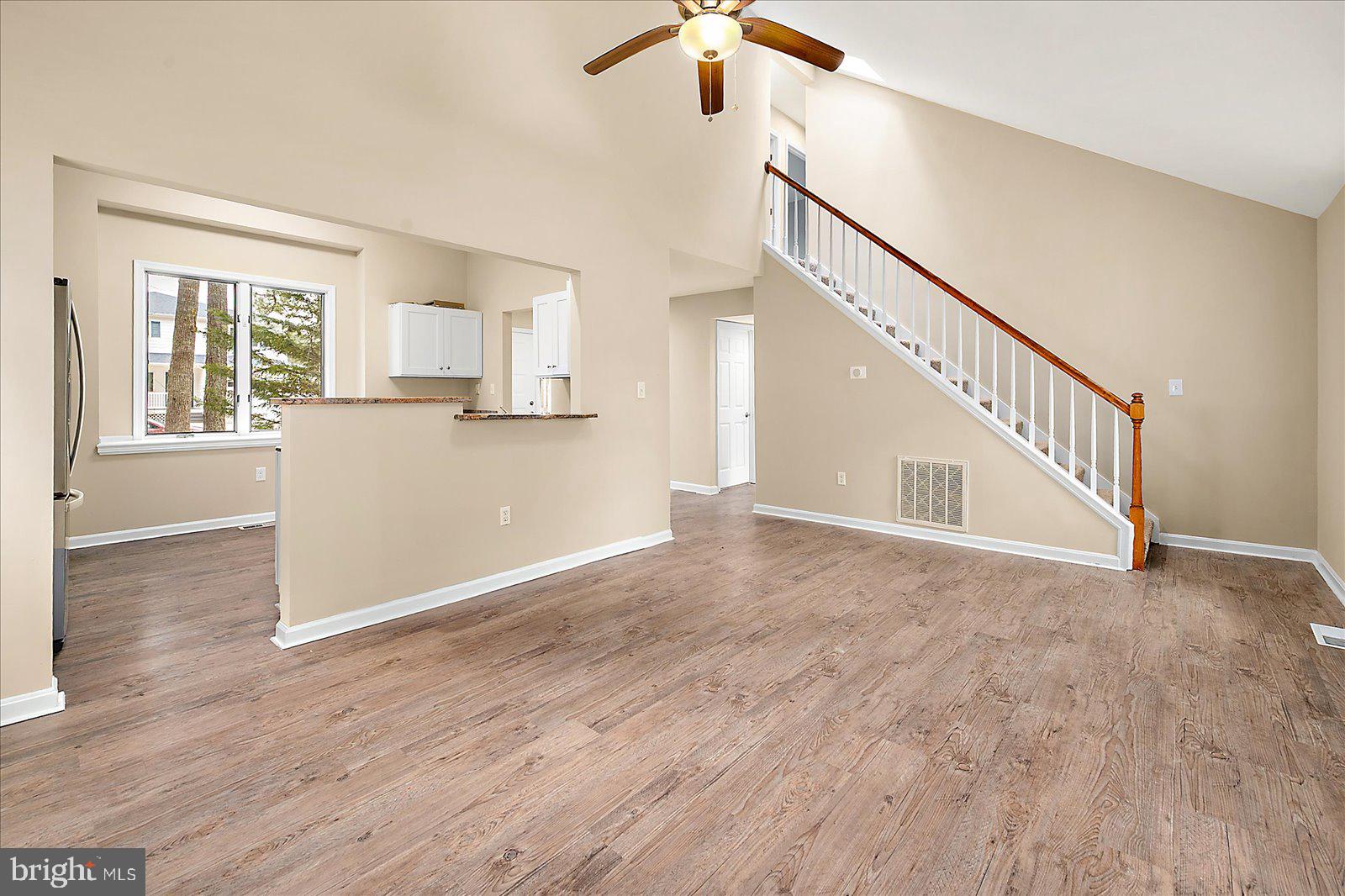 37 Watertown Road Ocean Pines, MD 21811 - Photo 11 of 86 a view of a livingroom with wooden floor and stairs