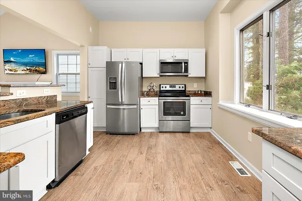 a dining room with furniture windows and wooden floor