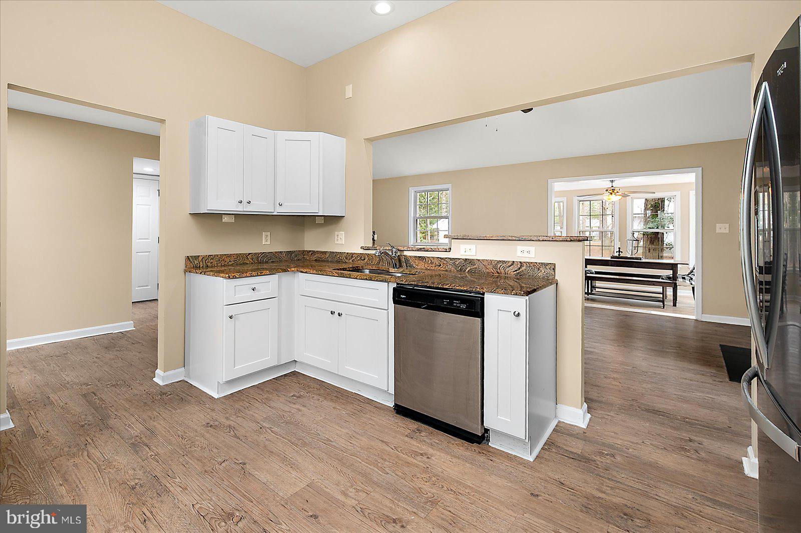 37 Watertown Road Ocean Pines, MD 21811 - Photo 14 of 86 a kitchen with stainless steel appliances granite countertop a stove top oven a sink dishwasher and white cabinets with wooden floor