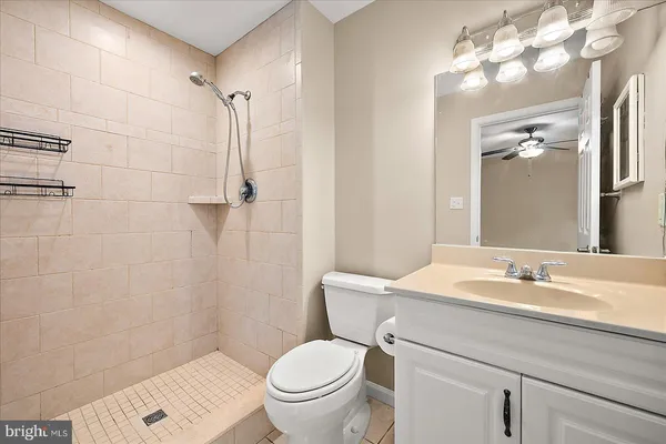 a bathroom with a sink toilet and a mirror