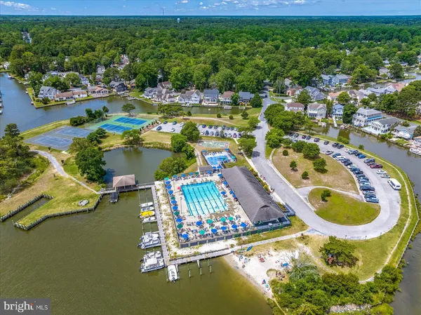 an aerial view of residential houses with outdoor space and lake view