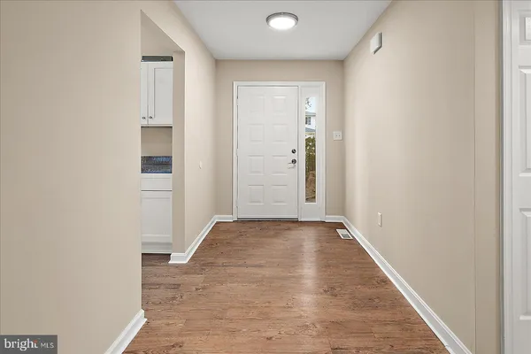 a view of a livingroom with wooden floor and stairs