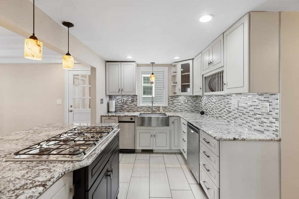 14 Church Street Westwood, MA 02090 - Photo 12 of 35 a kitchen with stainless steel appliances granite countertop a sink stove and refrigerator