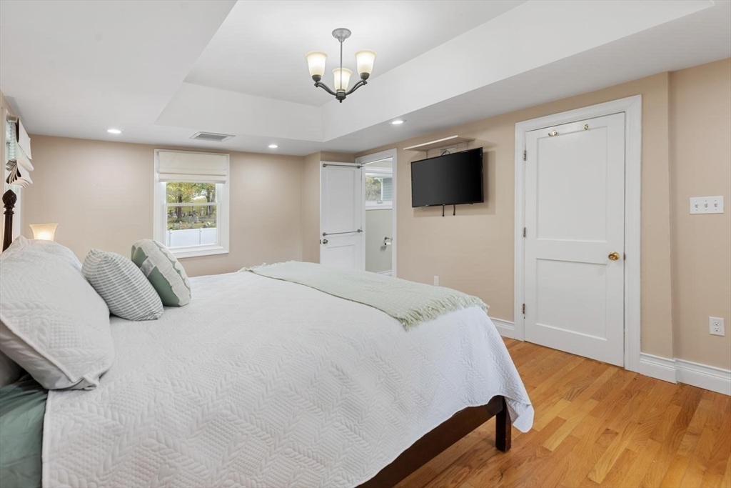 14 Church Street Westwood, MA 02090 - Photo 22 of 35 a bedroom with a large bed and a flat screen tv