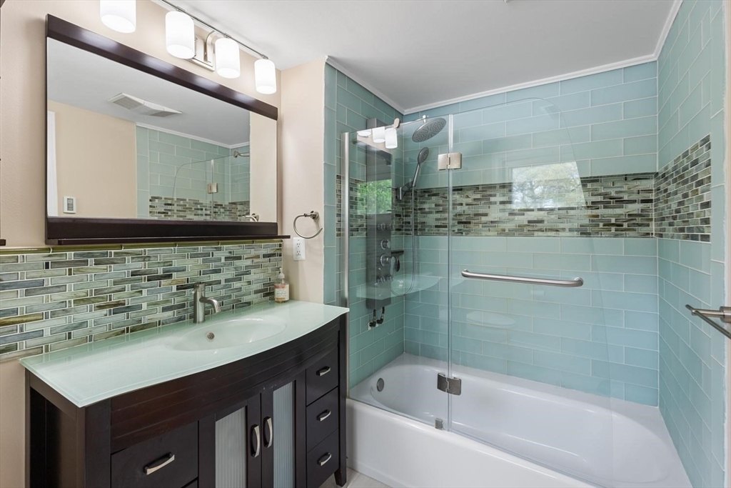 14 Church Street Westwood, MA 02090 - Photo 24 of 35 a bathroom with a bathtub sink vanity and mirror