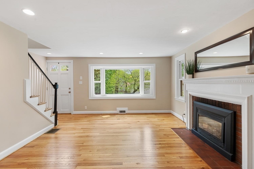 14 Church Street Westwood, MA 02090 - Photo 6 of 35 a view of an empty room with wooden floor fireplace and a window