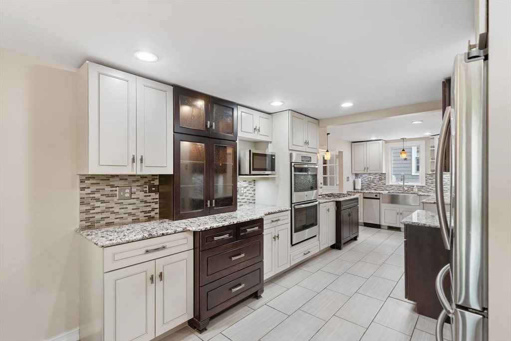 14 Church Street Westwood, MA 02090 - Photo 8 of 35 a kitchen with white cabinets and stainless steel appliances