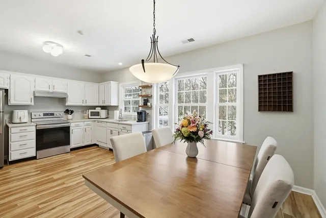 a large white kitchen with granite countertop lots of counter top space
