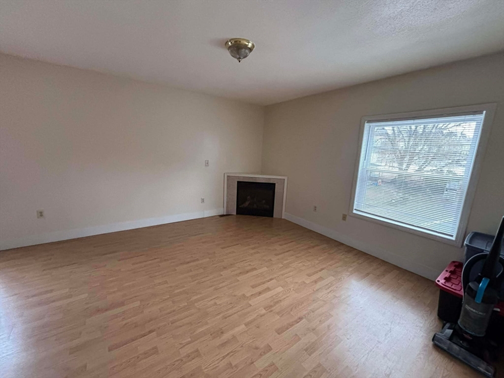 48 North Street, Unit 9 Gilbertville, MA 01031 - Photo 4 of 12 a view of an empty room with wooden floor and a window