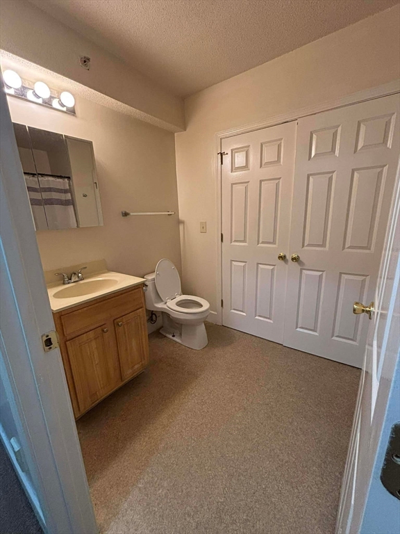 48 North Street, Unit 9 Gilbertville, MA 01031 - Photo 9 of 12 a bathroom with a sink a toilet and shower