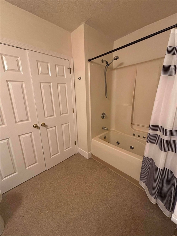 48 North Street, Unit 9 Gilbertville, MA 01031 - Photo 10 of 12 a bathroom with a tub a sink and a shower