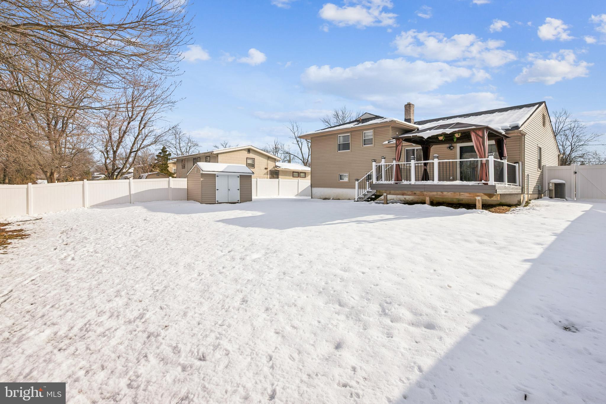 205 Avon Road Cherry Hill, NJ 08034 - Photo 21 of 25 a front view of a house with a yard covered in snow