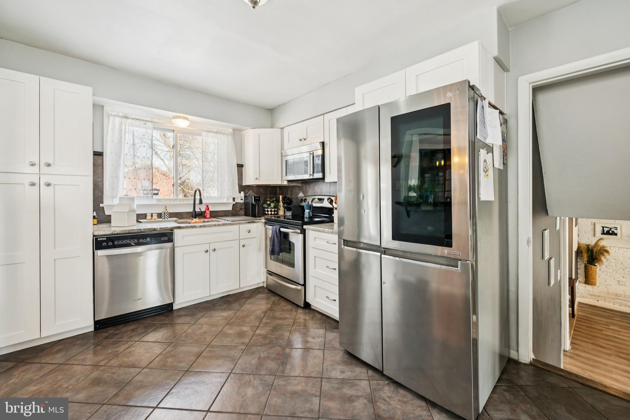 205 Avon Road Cherry Hill, NJ 08034 - Photo 10 of 25 a kitchen with white cabinets and white appliances