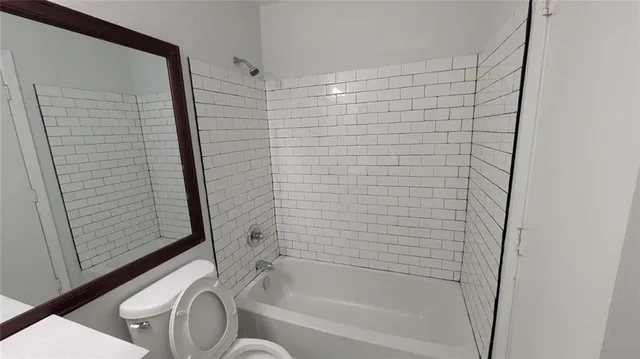 a bathroom with a bathtub and shower
