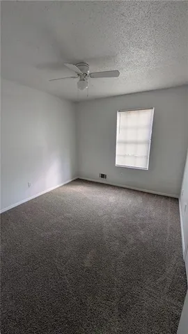 an empty room with a empty space and windows