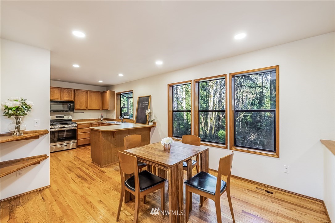 23511 Meridian Avenue South Bothell, WA 98021 - Photo 13 of 40 a view of a dining room with furniture window and wooden floor