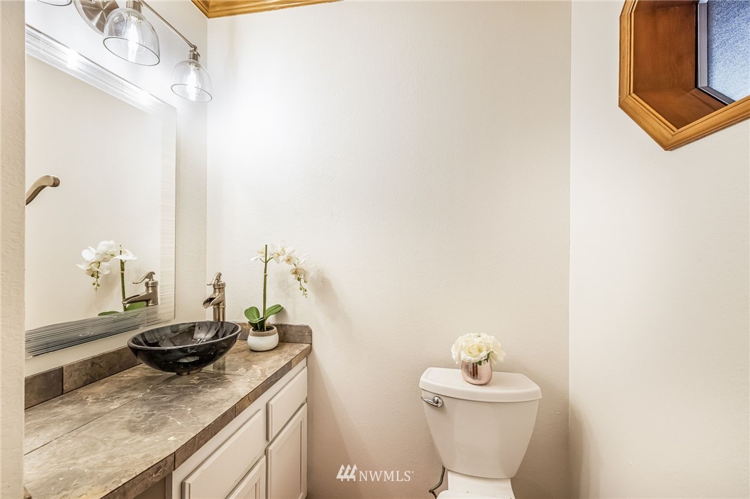 23511 Meridian Avenue South Bothell, WA 98021 - Photo 19 of 40 a bathroom with a granite countertop sink and a mirror