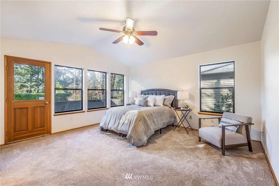 23511 Meridian Avenue South Bothell, WA 98021 - Photo 23 of 40 a spacious bedroom with a bed and chair