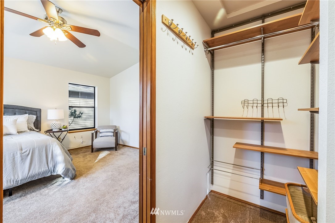 23511 Meridian Avenue South Bothell, WA 98021 - Photo 25 of 40 a bedroom with a bed and a chandelier