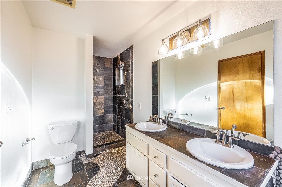 23511 Meridian Avenue South Bothell, WA 98021 - Photo 27 of 40 a bathroom with a double vanity sink toilet and shower